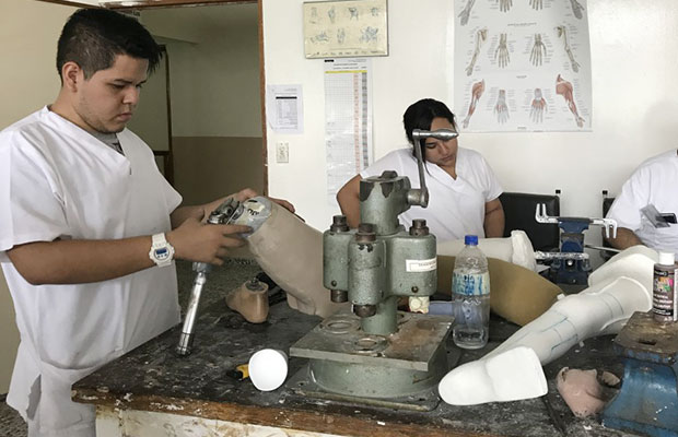A group of people working together on prosthetics for the disabled