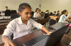 Feb 2025 enews -story #1 - New Tools for Learning - Sri Lanka - girl in a white shirt using a laptop computer in a computer lab at school