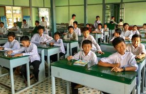 Feb 2026 enews - story 1 - myanmar - Young Earthquake Victims Find Hope at Don Bosco Youth Center - children, students, classroom, green, desks, smiles, happy, asia